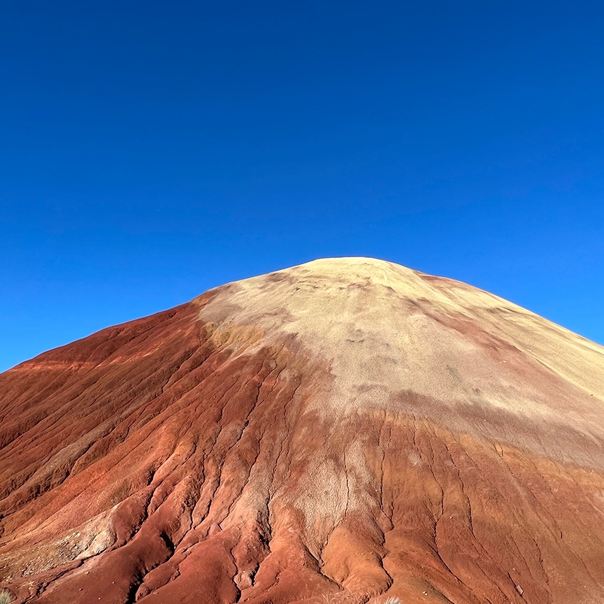 image of orange mountain against blue sky